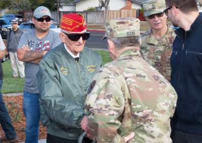 Veteran and Colonel Jon Ellis shaking hands, Monument dedication Saturday, November 11, 2017